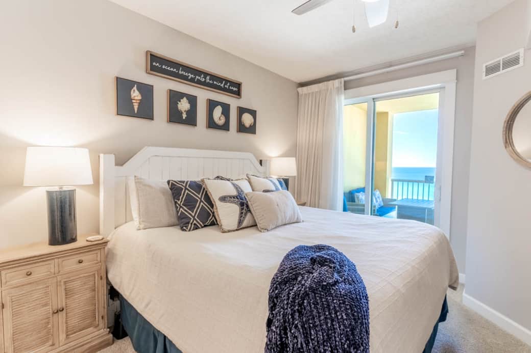 Primary bedroom with king bed and balcony view